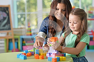 Portrait of little girl playing with mother