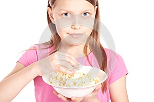 Portrait of a little girl with popcorn on white