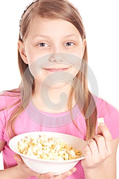 Portrait of a little girl with popcorn on white