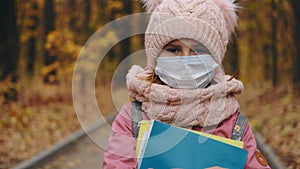 Portrait of little girl in protective mask