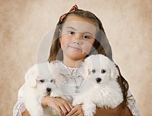 Portrait of a little girl with puppies