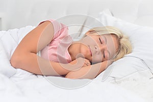 Portrait of little girl sleeping in her bed