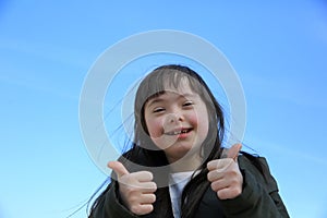 Portrait of little girl smiling on background of the blue sky