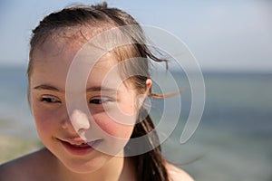 Portrait of little girl smiling on the background of the sea