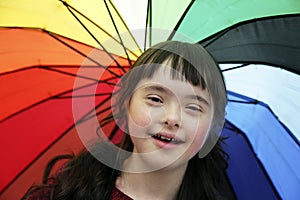 Portrait of little girl smiling on background of the umbrella.