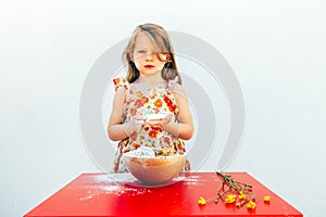 Portrait of a little girl with a soiled face flour