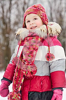 Portrait of little girl standing in winter park