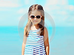 Portrait little girl in sunglasses agains