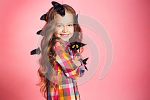 Portrait of a little girl with tropical butterflies.