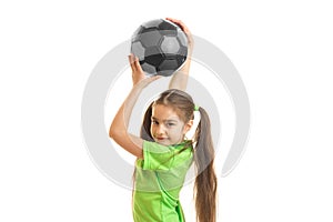 Portrait of a little girl which is raised above the head soccer ball