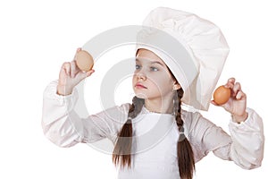 Portrait of a little girl in a white apron holding two chicken e