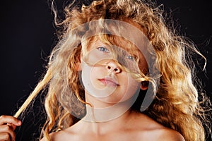 Portrait of little girl with windy hair. Fashion photo