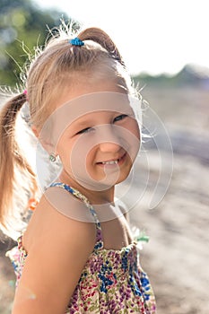 Portrait of a little girl with a wobbly baby tooth