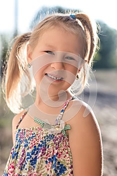 Portrait of a little girl with a wobbly baby tooth