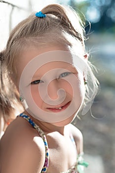 Portrait of a little girl with a wobbly baby tooth