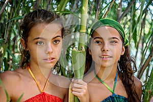 Portrait of little girls in the bushes