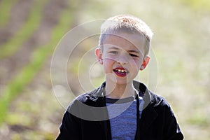 Portrait of little handsome serious cute blond boy with funny un