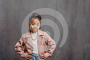 Portrait of little japanesse girl with leather jacket. photo