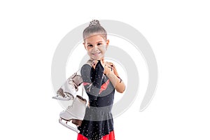 Portrait of little laughing skater with skates in her hands