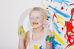 Portrait of a little messy kid painter. School. Preschool. Education. Creativity. Studio portrait over white background