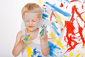 Portrait of a little messy kid painter. School. Preschool. Education. Creativity. Studio portrait over white background