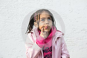 Portrait of little mixed girl thinking