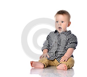 Portrait of a little one year old baby boy crying on a white background.