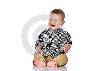 Portrait of a little one year old baby boy crying on a white background.