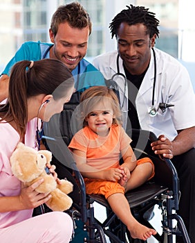 Portrait of a little patient with medical team