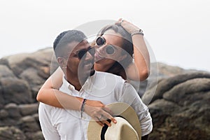 Portrait of living young couple at the beach. They are happy and smile. Concept of just married family