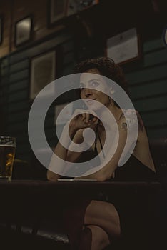 Portrait of a lone woman at a bar