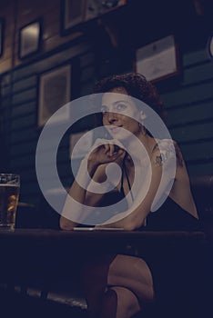 Portrait of a lone woman at a bar