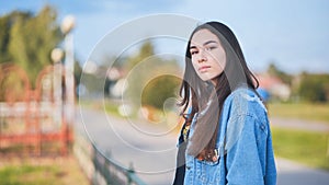 Portrait of a lonely girl by a lake.