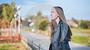 Portrait of a lonely girl by a lake.