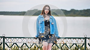 Portrait of a lonely girl by a lake.