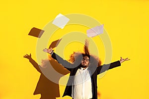 portrait of long-haired businessman throwing papers and documents in the air