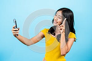 portrait, long haired girl wearing shirt yellow tights, in her hand holding laptop, lifted laptop up high, in order take selfies,