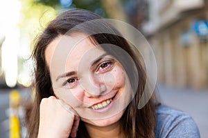 Portrait of longhaired woman standing outdoors in city