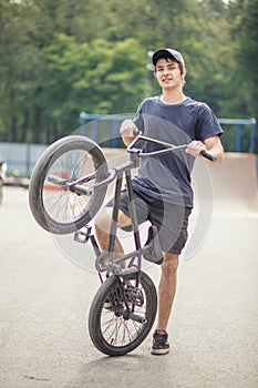 Portrait of lookin girl posing in skate park with bmx