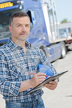 Portrait lorry driver with clipboard