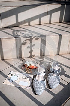 Portrait of Love: Sandals, Wedding Invitation, and Sunlit Stairs