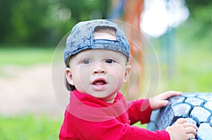 Portrait of lovely baby boy age of 10 months outdoors