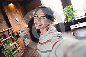 Portrait of lovely cheerful girl toothy smile make selfie record video spacious modern house indoors