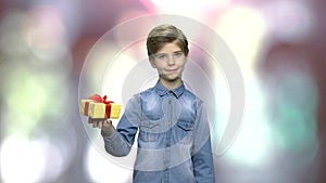 Portrait of lovely child holding gift box.