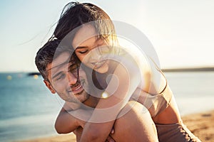 Portrait of lovely couple in love having fun on the beach. Young beautiful people hugging . Romantic moment. Valentine`s day