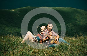 Portrait of lovely couple in love. Young couple playing guitar. Romantic music and happy couple relationships. Romance