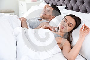 Portrait of lovely couple sleeping in bed