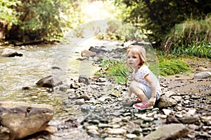 Portrait of lovely cute little girl on the riverside