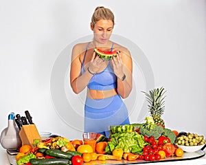 Portrait of  a lovely fitness blonde woman with heap Of vegetables. Isolated.