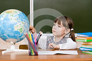 Portrait of lovely girl considers Globe